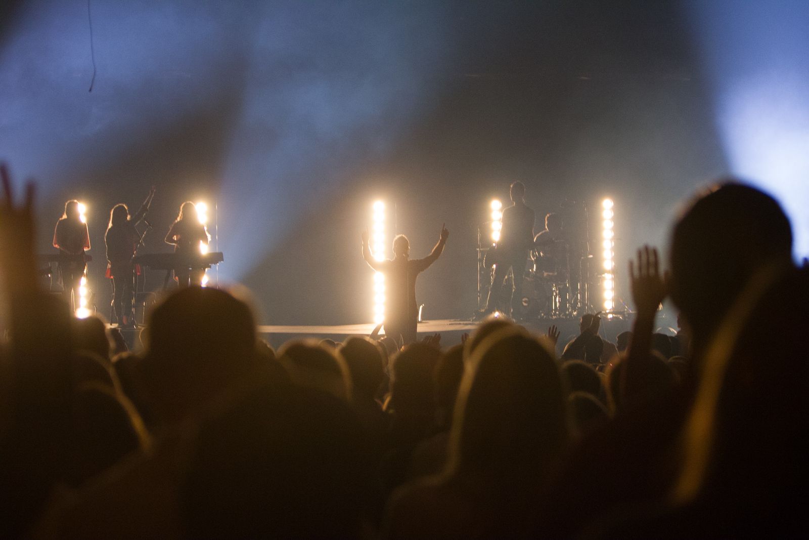 Audience raising their hands at a live concert